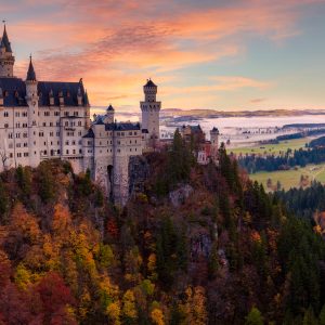 Neuschwanstein Castle at sunrise with autumn colors