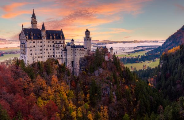 Neuschwanstein Castle at sunrise with autumn colors